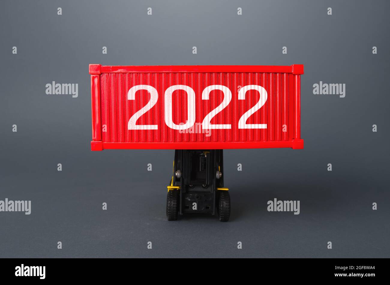 Forklift holds a container with 2022. Analytics forecasting of freight traffic next year. Express air delivery, goods transportation. Logistics. Impor Stock Photo