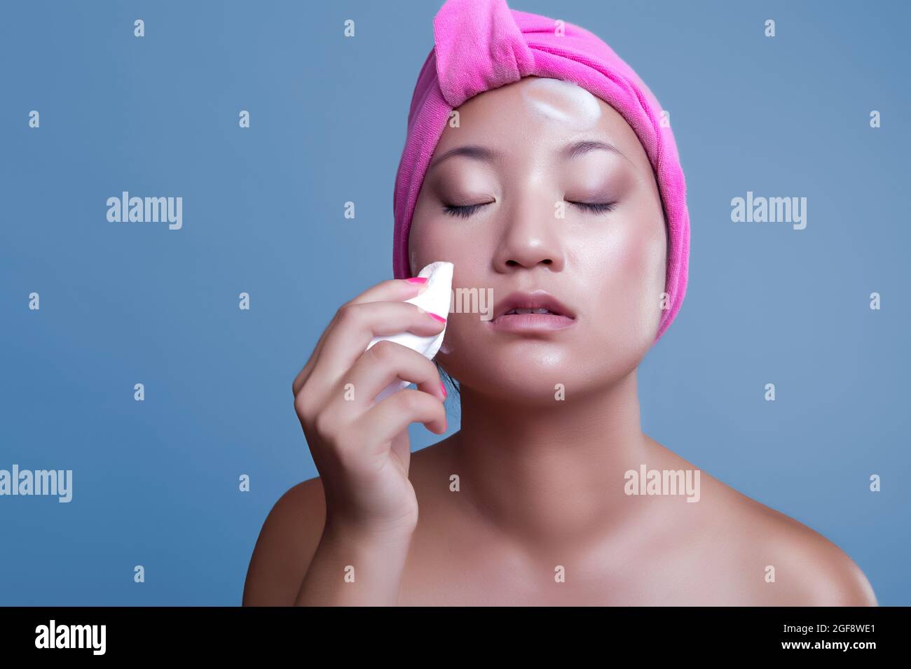 pretty chinese woman taking care of her skin isolated from the background, beauty concept Stock Photo