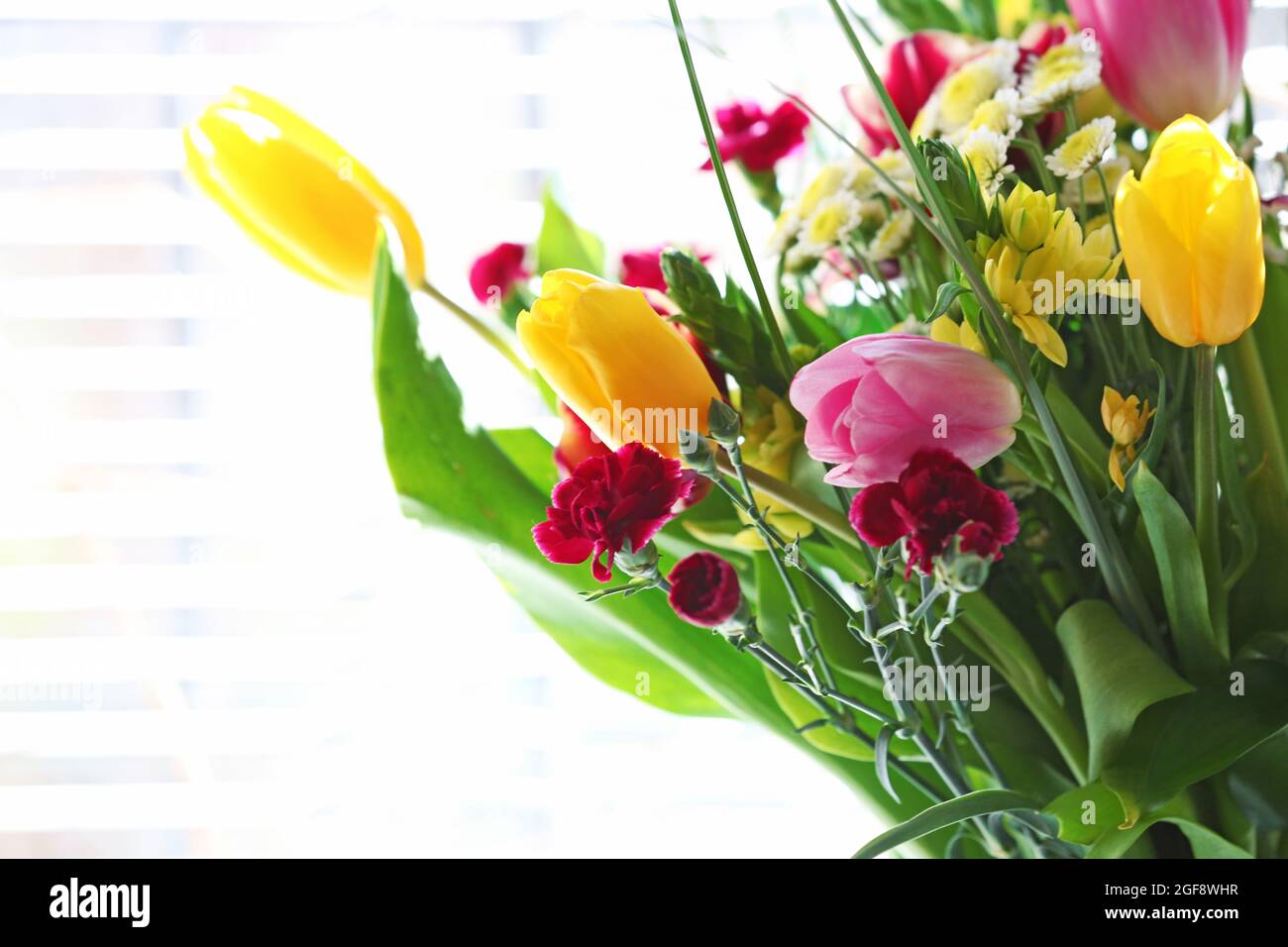 Bouquet of fresh flowers by the window Stock Photo Alamy