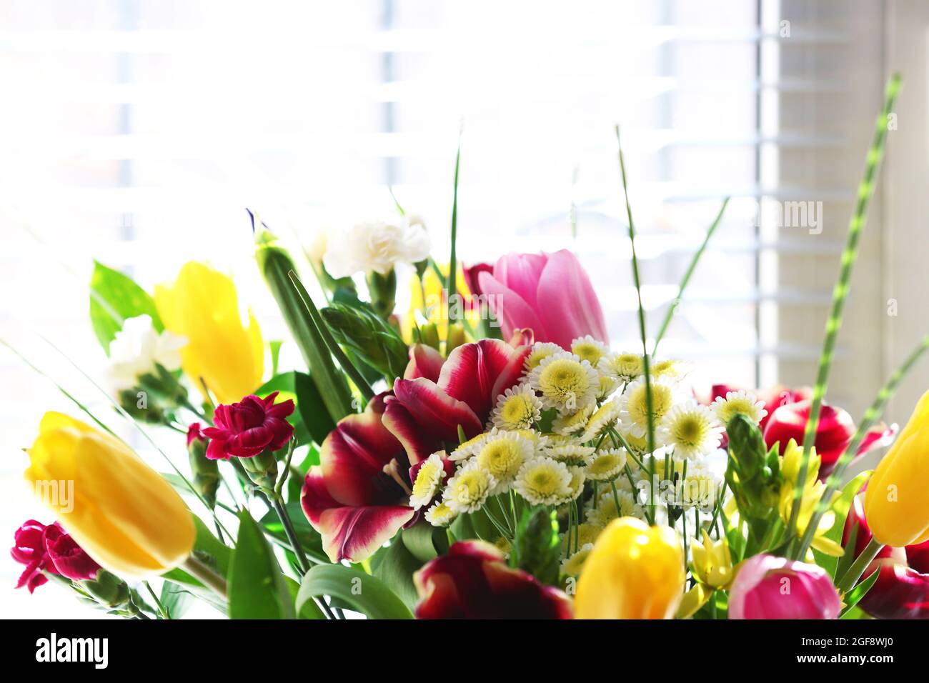 Bouquet of fresh flowers by the window Stock Photo Alamy