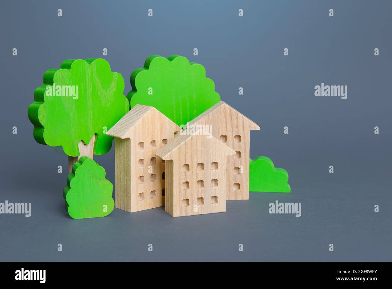 Residential buildings among the trees. Environmentally friendly, energy efficiency, zero carbon emissions. Carbon neutrality. Buying and selling real Stock Photo