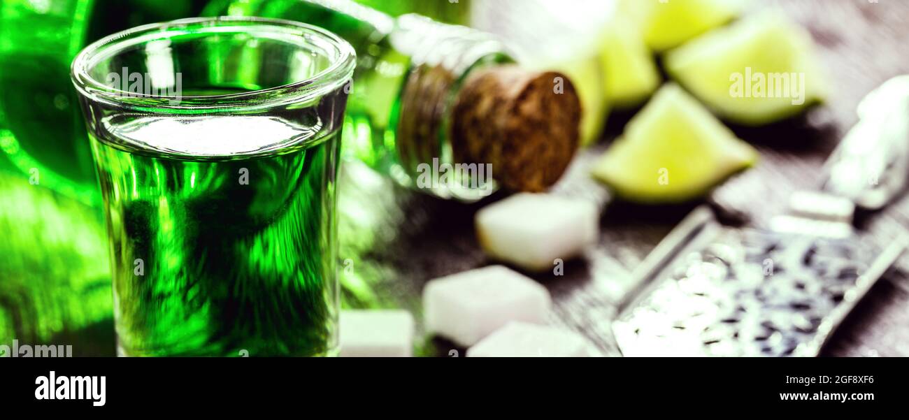 doses of absinthe with sugar cubes. Absinthe bottle, green distilled drink Stock Photo Alamy