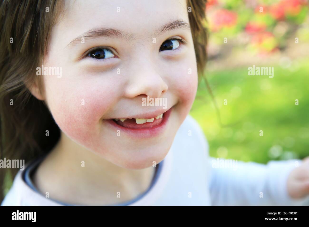Portrait of little girl smiling outside Stock Photo - Alamy