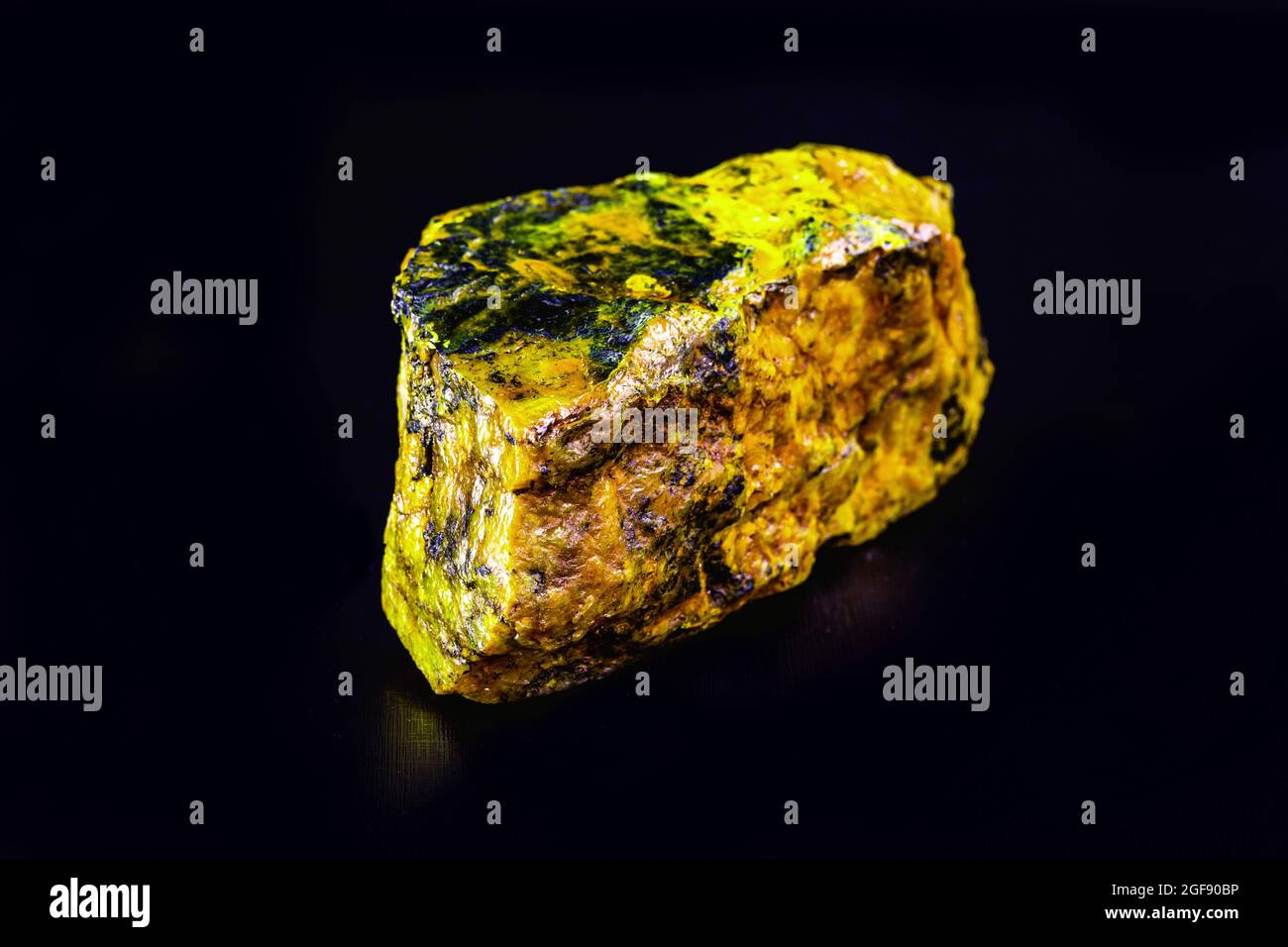 uranium mineral isolated on black background. Highly radioactive and