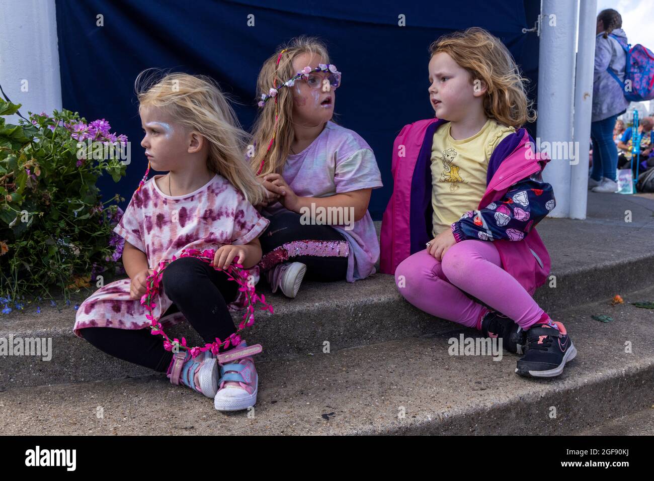 Children of performers sit by the edge of the bandstand at Broadstairs Folk Week, August 2021 Stock Photo