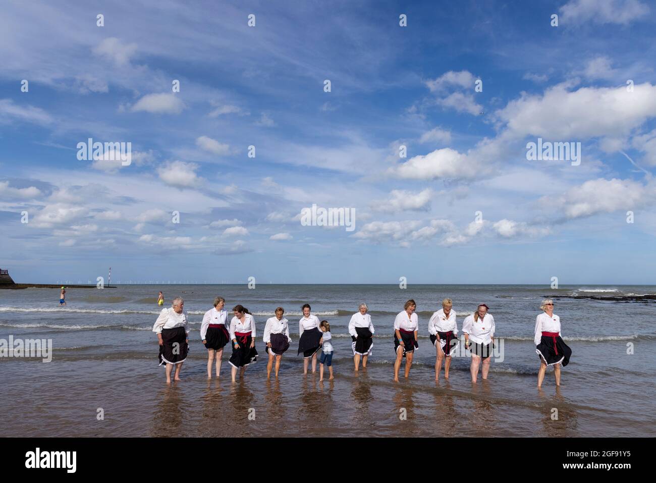 Dead Horse Morris group of morris dancers take a paddle in Viking Bay after performing at Broadstairs Folk Week, August 2021 Stock Photo