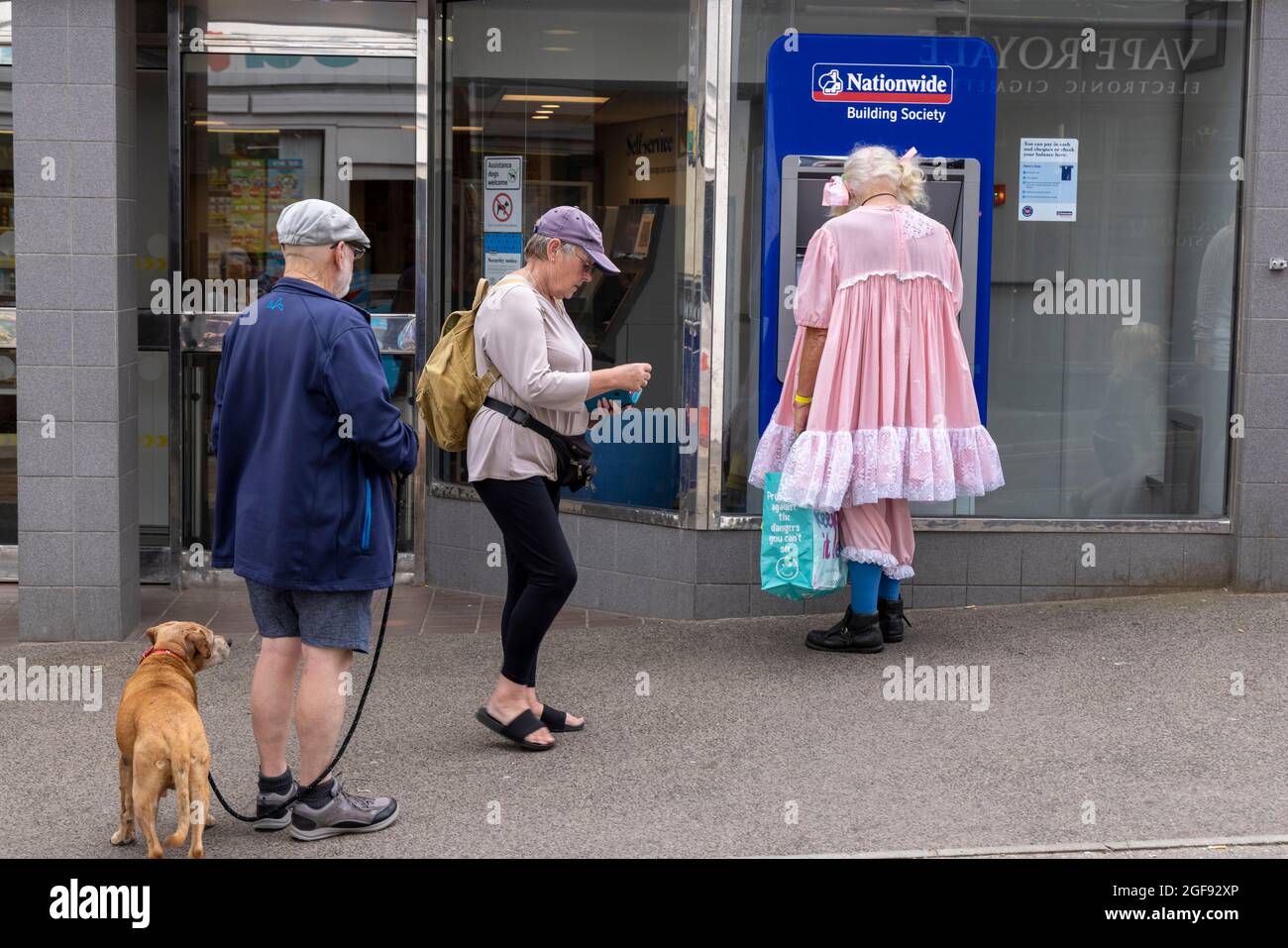 Trinity Morris clog dance group organiser in his baby girl costume getting cash during Broadstairs Folk Week, August 2021 Stock Photo