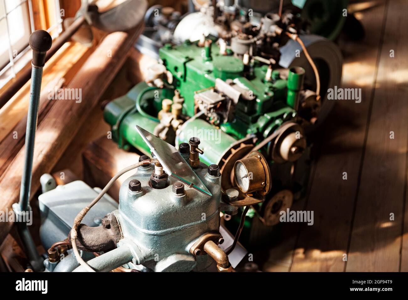 different types of old engines in a row by the window Stock Photo