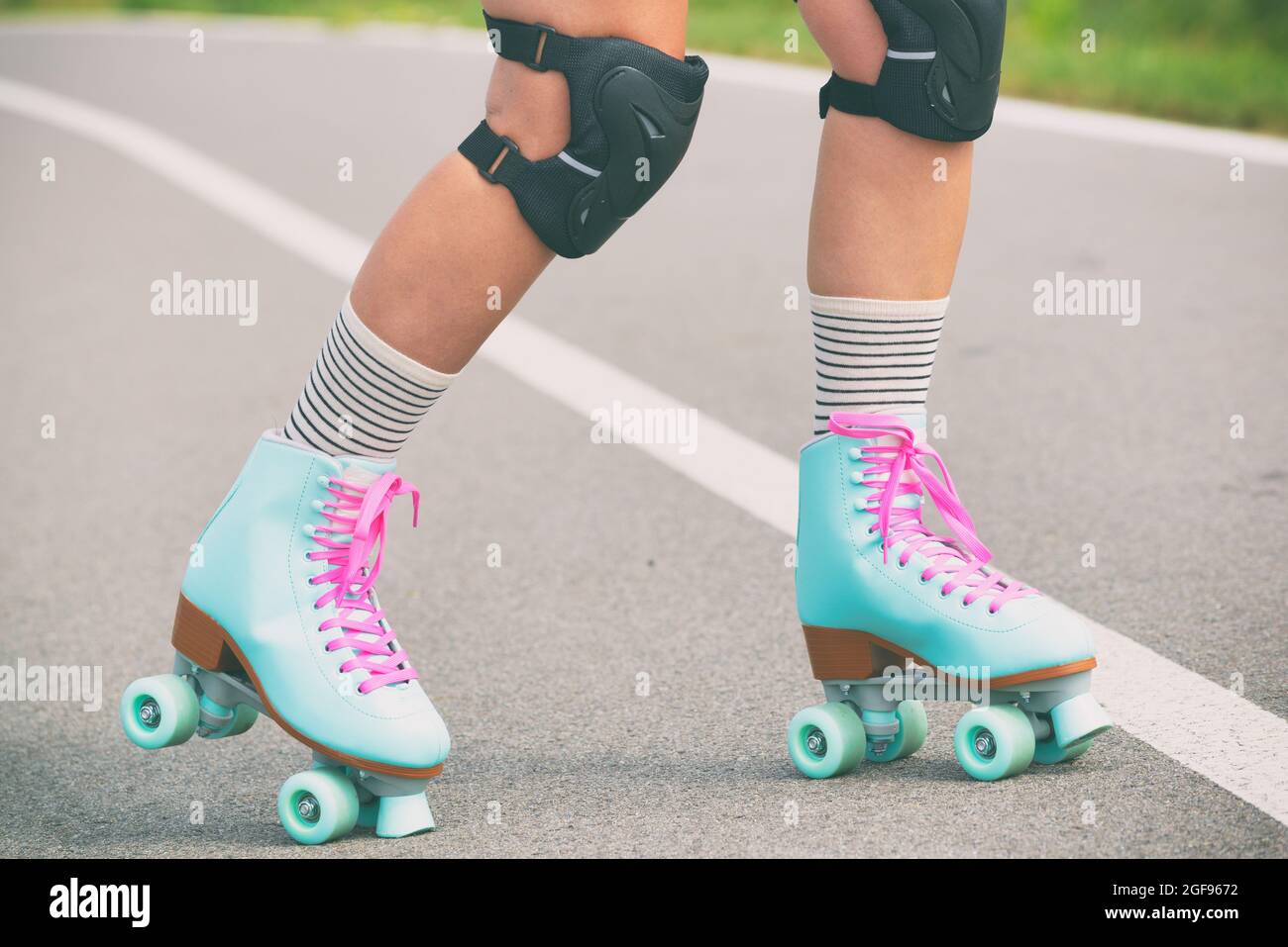 Woman rollerskater wearing knee protector pads on her leg Stock Photo
