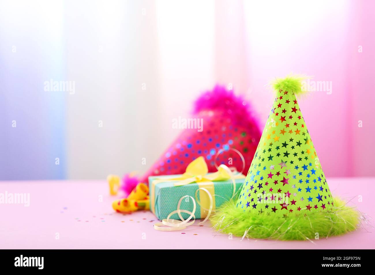 Party hats on bright background Stock Photo - Alamy