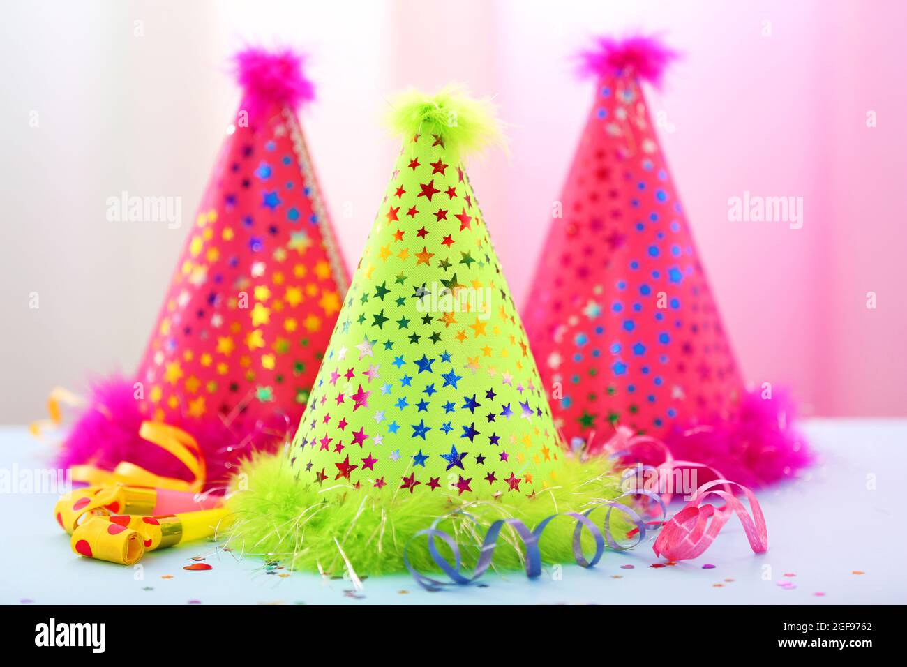 Party hats on bright background Stock Photo - Alamy