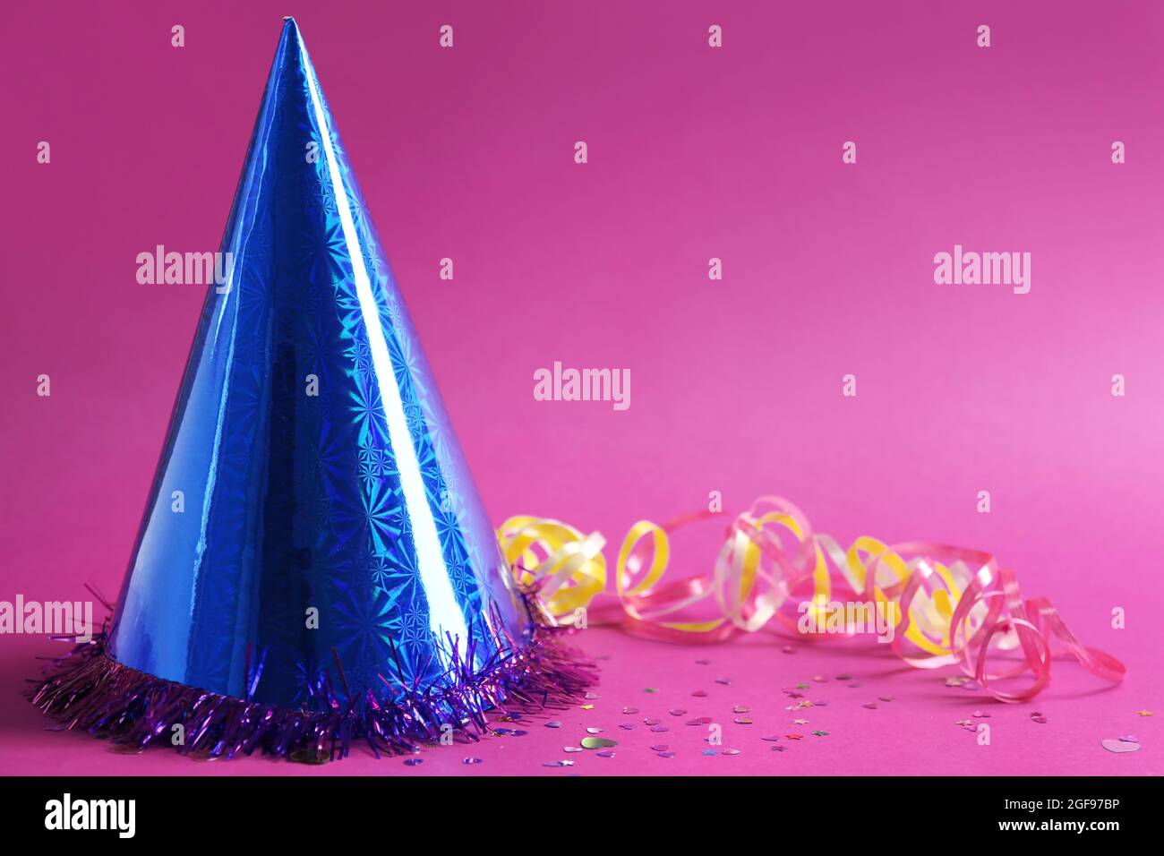 Funny party hat on purple background Stock Photo - Alamy