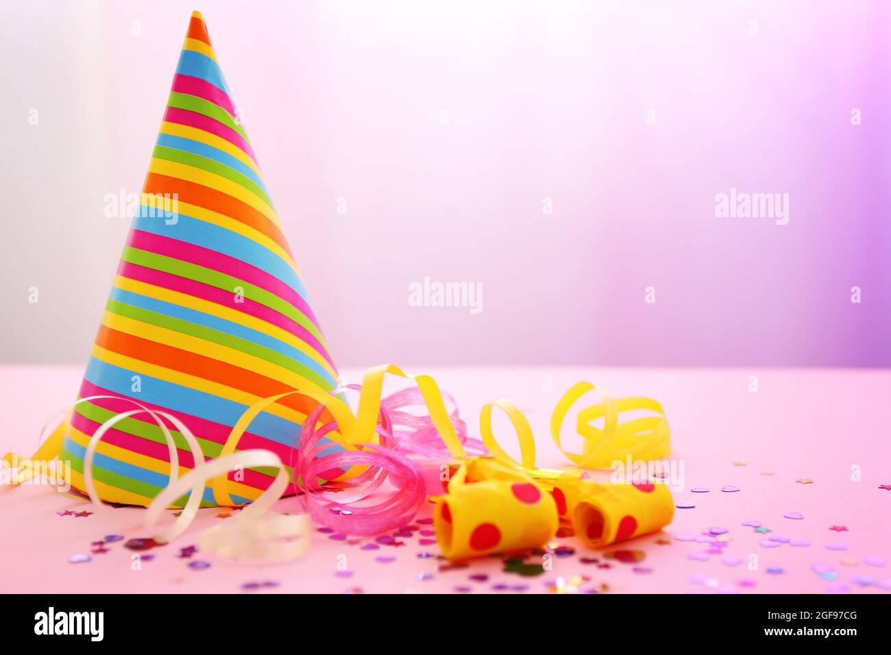 Party hat on bright background Stock Photo - Alamy