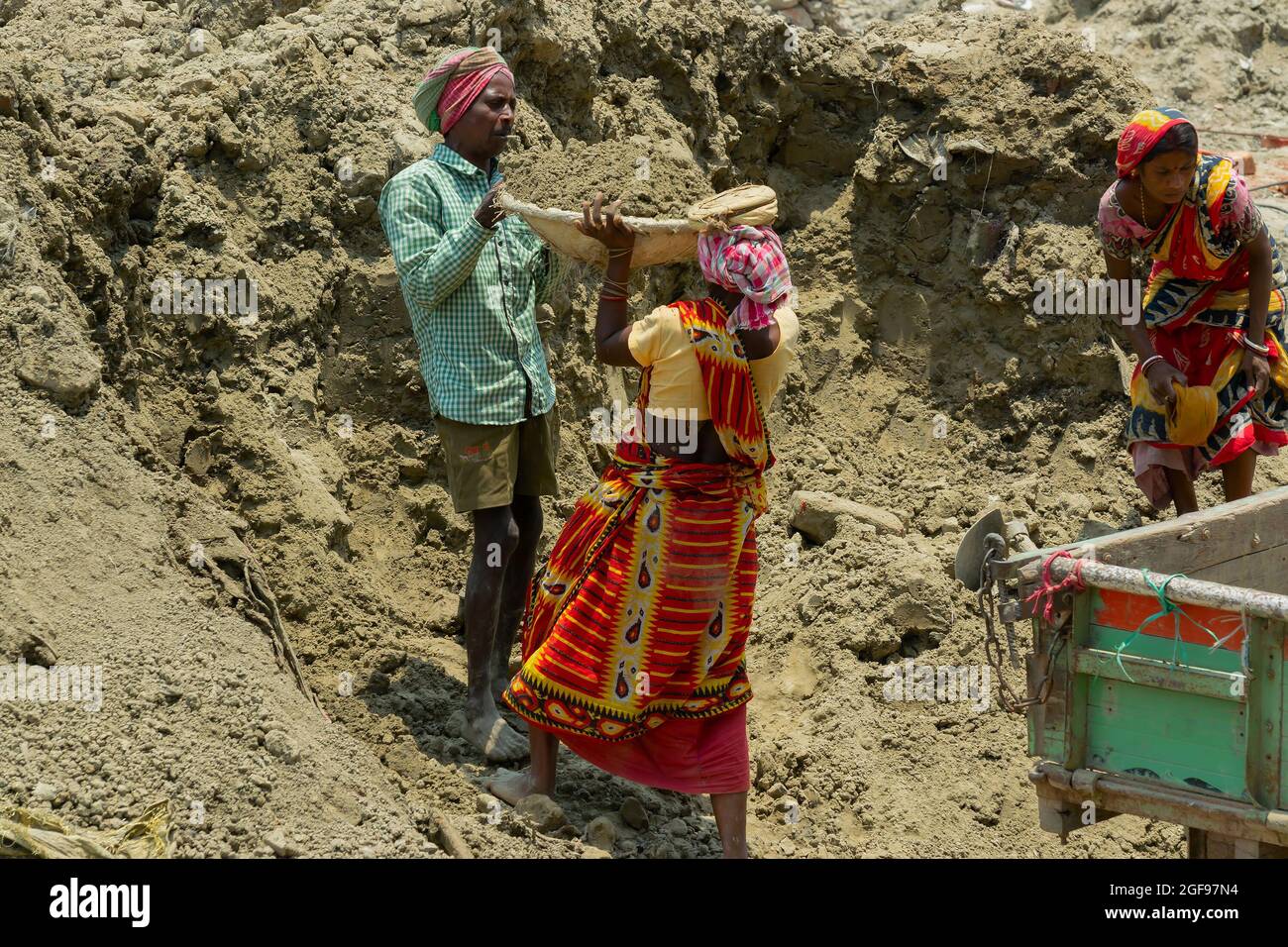 Howrah, West Bengal, India - 7th May 2017 : Indian male and female workers digging and carrying out soil at buliding construction site. India has a hu Stock Photo