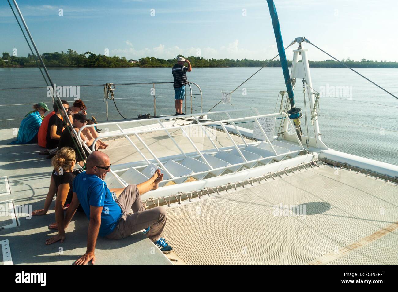 KOUROU, FRENCH GUIANA - AUGUST 2, 2015: Tourists aboard modern catamaran on their way to Iles du Salut (Islands of Salvation) in French Guiana. Stock Photo