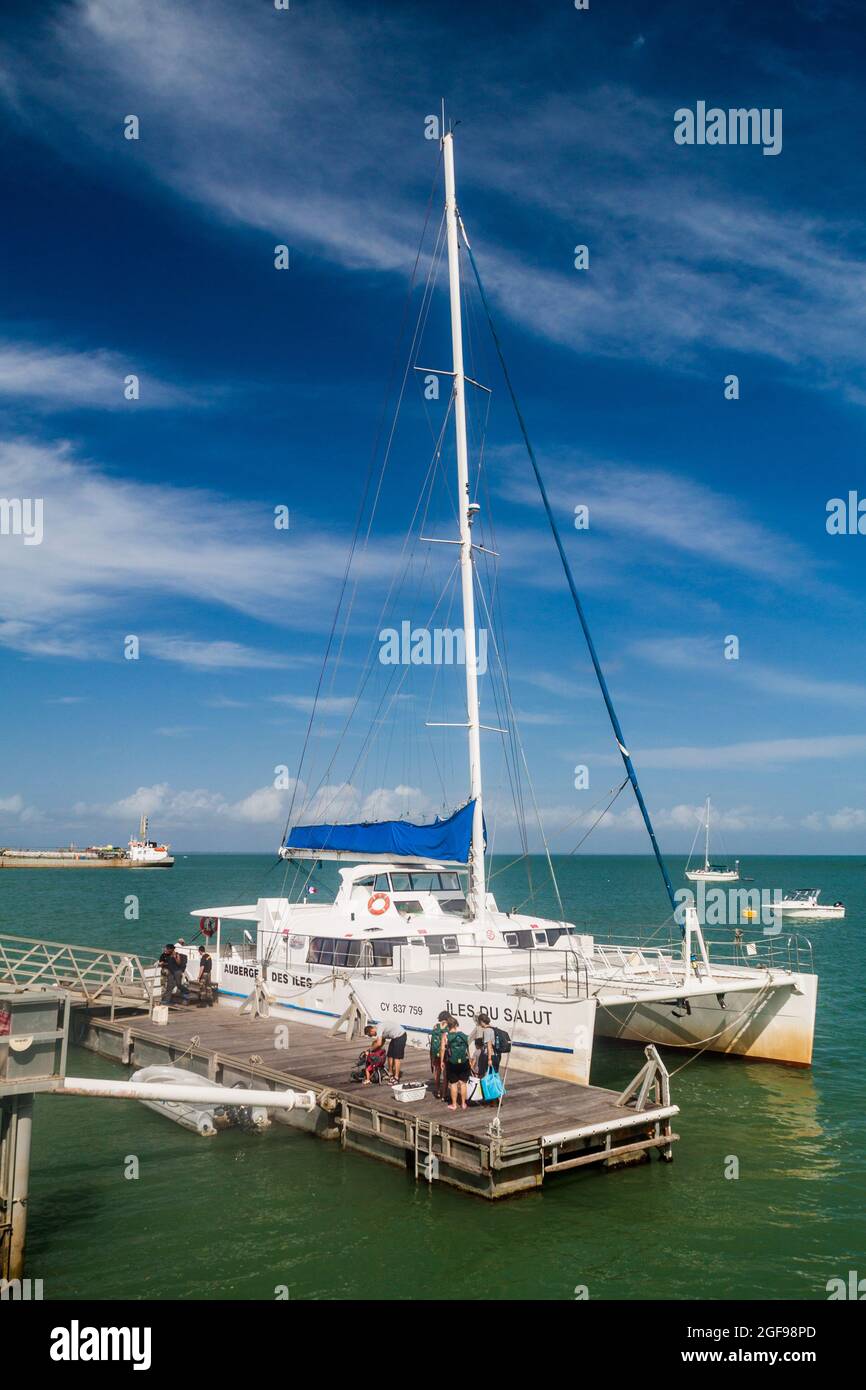 ILE ROYALE, FRENCH GUIANA - AUGUST 2, 2015:  Modern catamaran anchored by Ile Royale, one of the islands of Iles du Salut (Islands of Salvation) in Fr Stock Photo