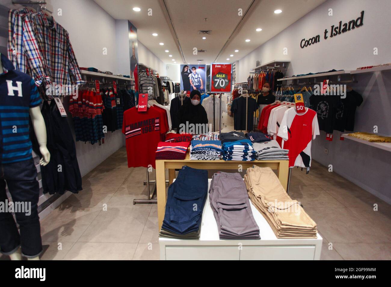 A women choice the clothes with sale discounts at a shopping mall after