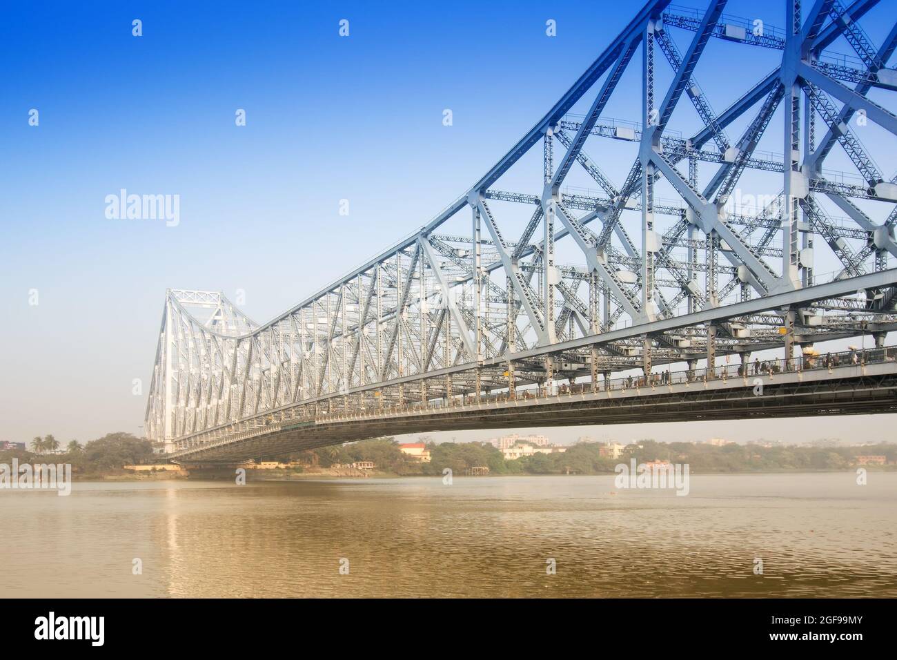 Famous Howrah Bridge connecting Howrah and Kolkata, a propped cantilever bridge with a suspended span over the Hooghly River in West Bengal, India. Co Stock Photo
