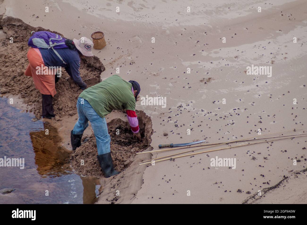GRAN SABANA, VENEZUELA - AUGUST 13, 2015: Indigenous fishermen are looking for worms in Gran Sabana region of Venezuela Stock Photo