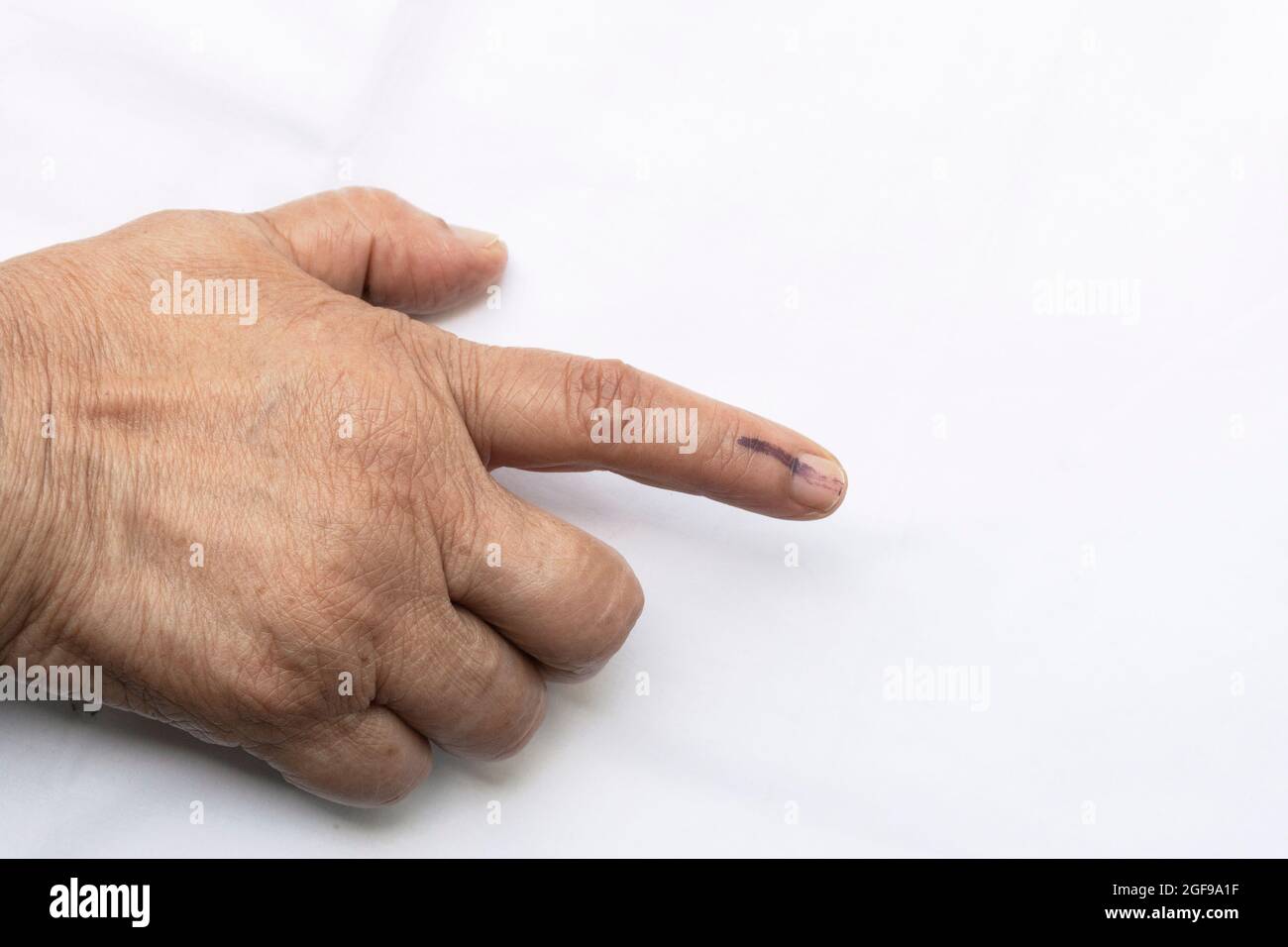 A senior citizen Indian woman voted , exercized her voting right and got her index finger inked. India is the largest democratic country in the world Stock Photo