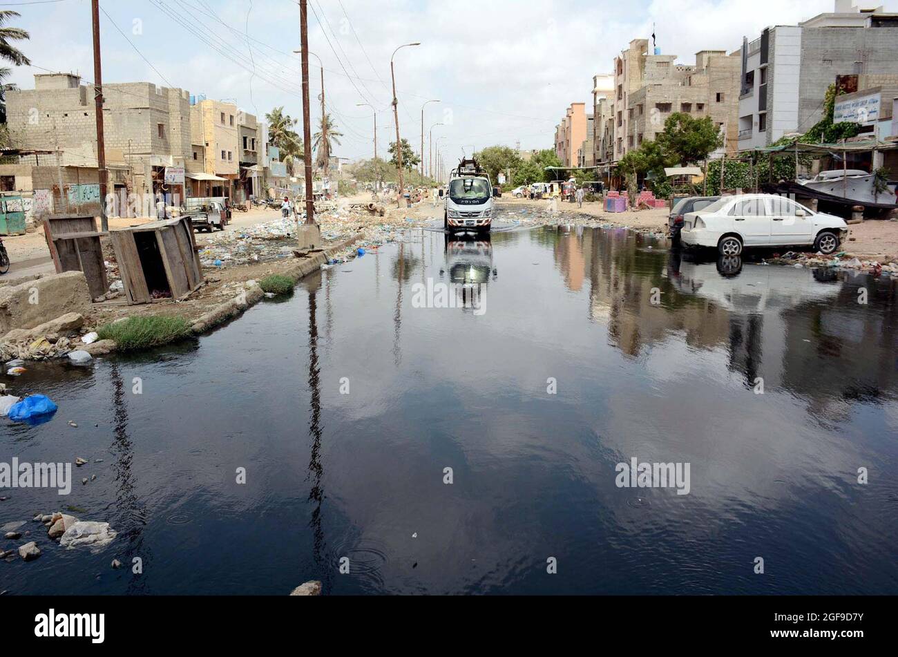 Inundated road by sewerage water, causing unhygienic atmosphere and creating problems commuters, showing negligence of concerned authorities, located on Korangi Graveyard road in Karachi on Tuesday, August 24, 2021. Stock Photo