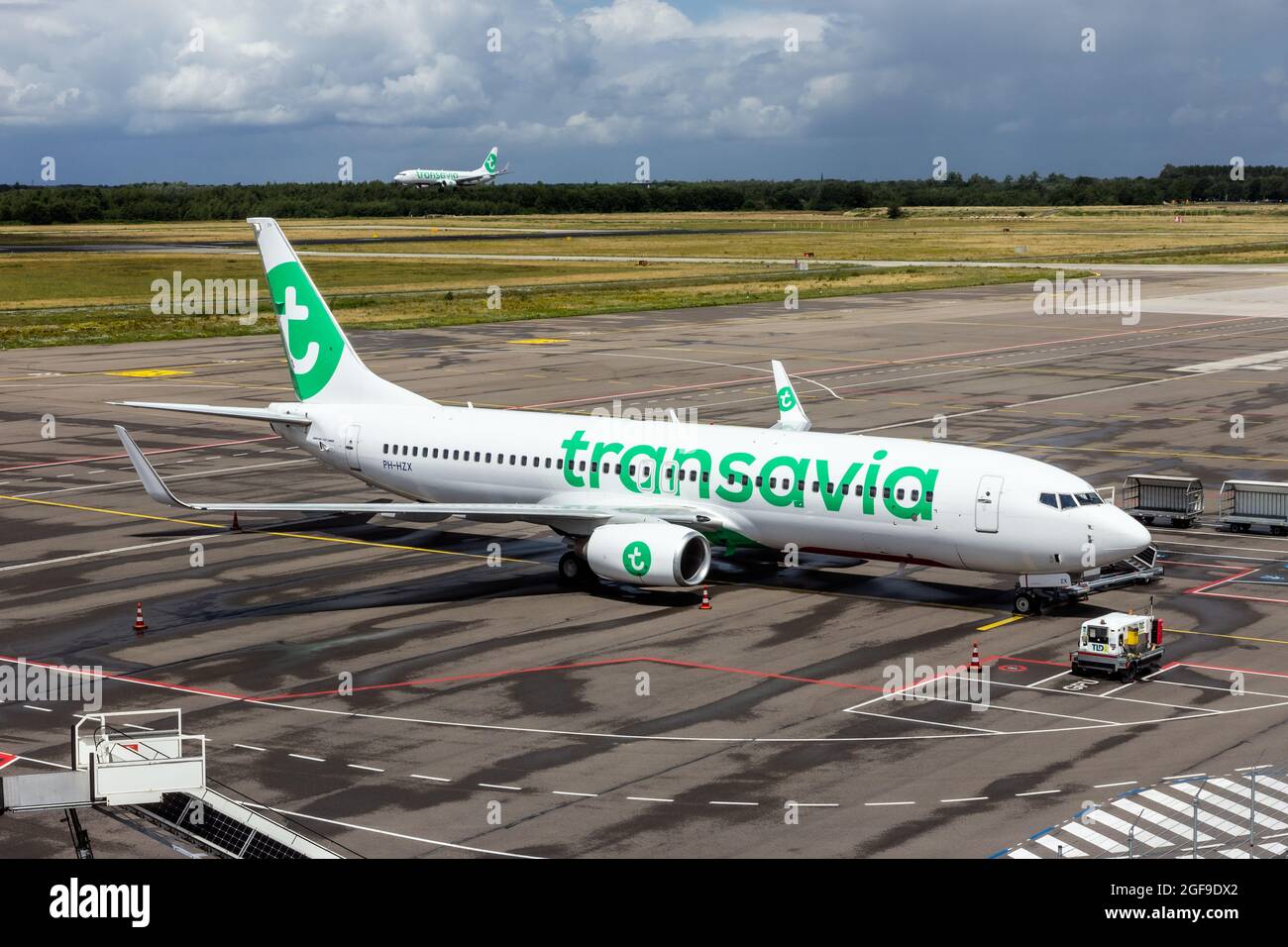 Transavia Boeing 737 passenger planes at the terminal and landing at Eindhoven Airport. The Netherlands - July 6, 2020 Stock Photo