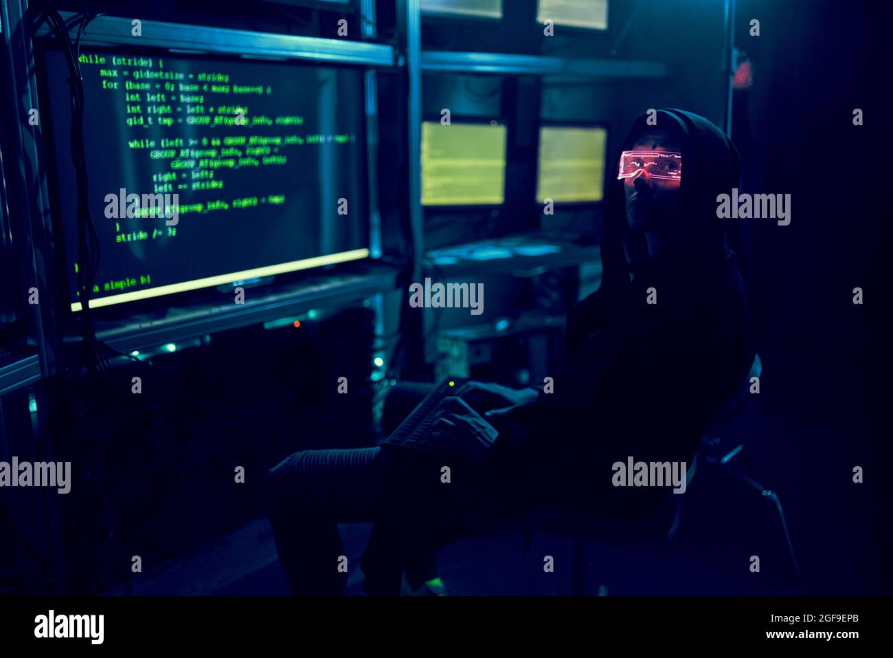 Cyber hacker breaks into databases to obtain information using a computer. Cybercrime and data security concept. Stock Photo