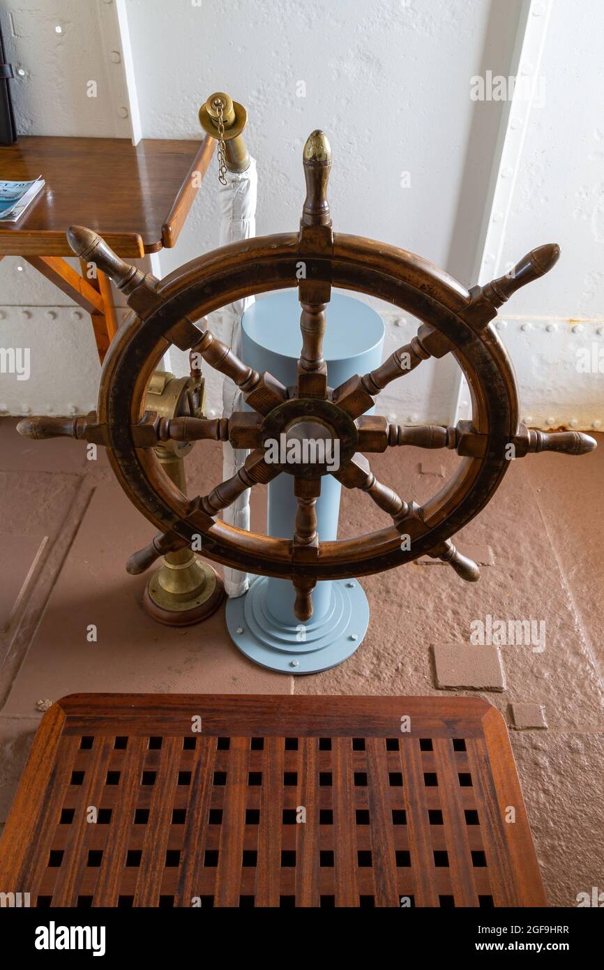 08-24-2021 Portsmouth, Hampshire, UK, A wooden ships wheel in the wheelhouse or Bridge of a ship Stock Photo