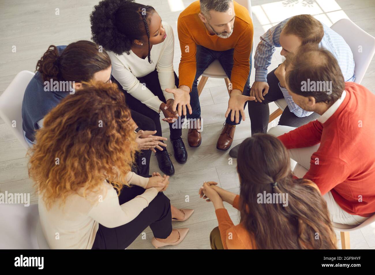 High angle shot of diverse people working on their problems in group therapy session Stock Photo