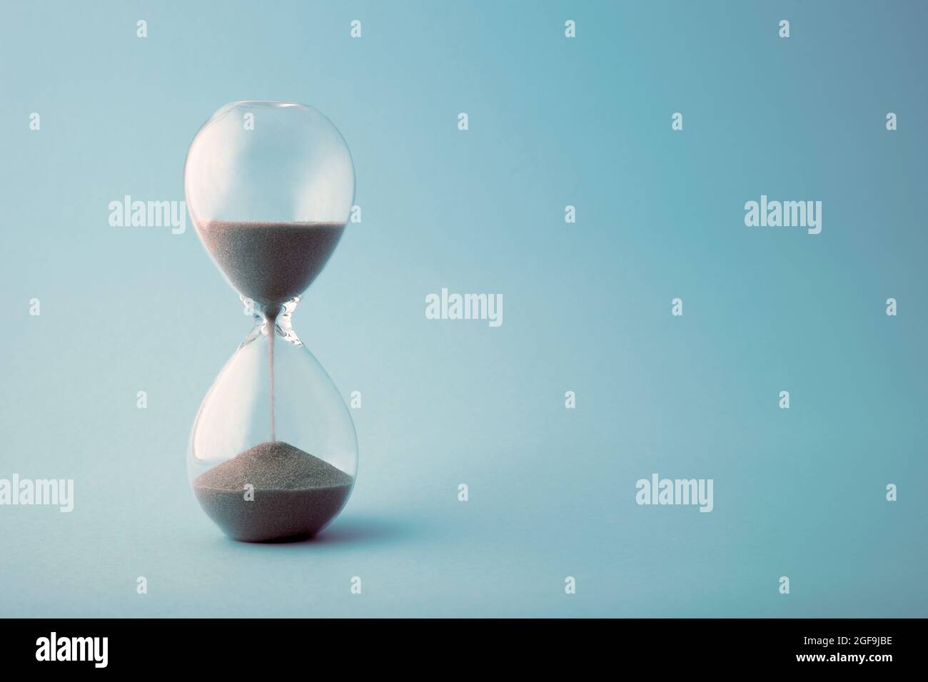 Hourglass time clock in blue tone Stock Photo Alamy