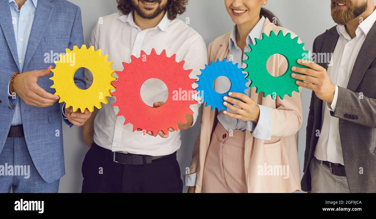 Business team holding gears to illustrate concept of effective teamwork and collaboration Stock Photo