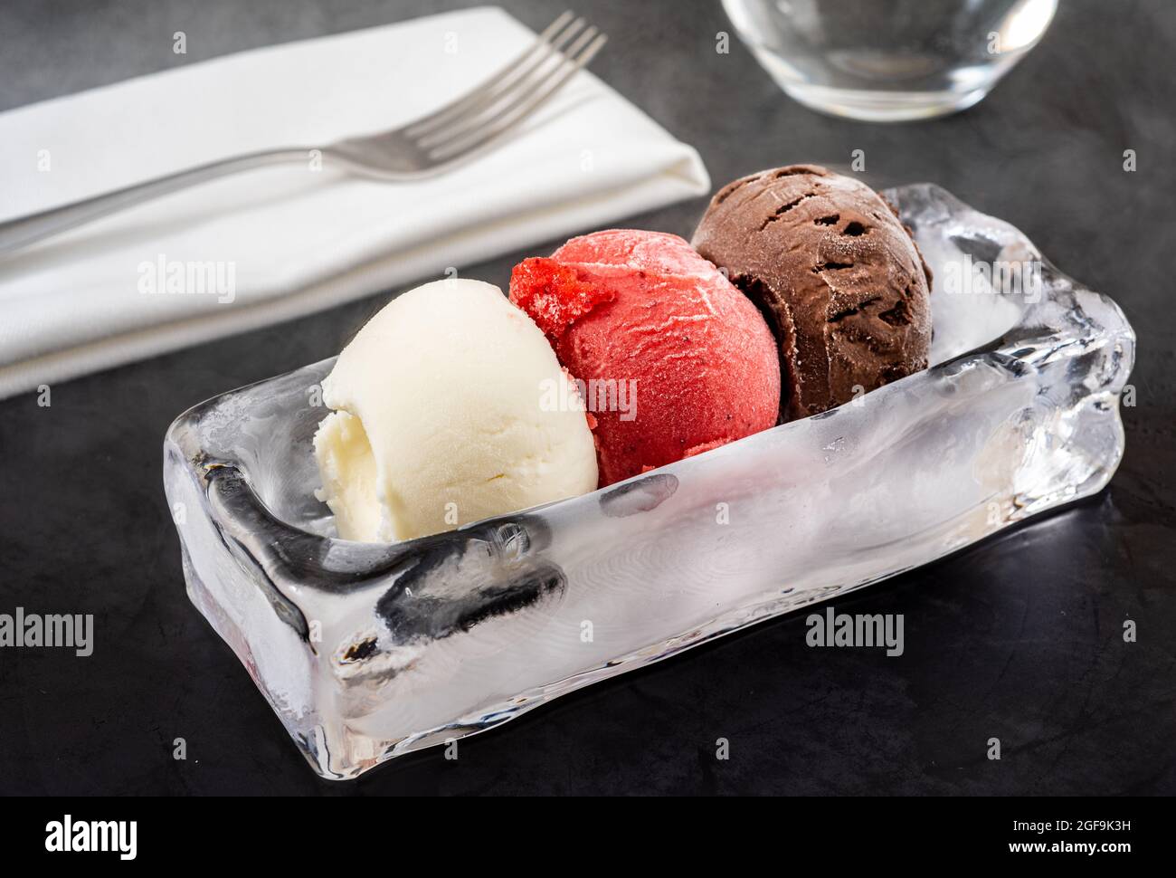 Strawberry and vanilla ice cream in ice bowl on black background Stock ...