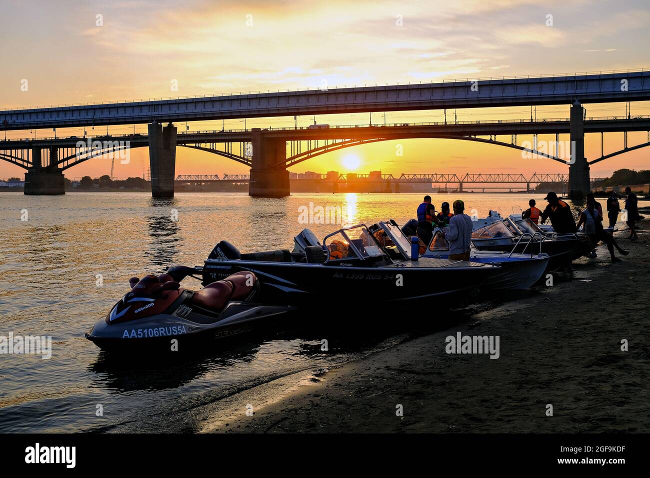 Novosibirsk city editorial photo. Boats on the banks of the Ob river against the backdrop of a stunning sunset. Illustrative photo about Novosibirsk c Stock Photo