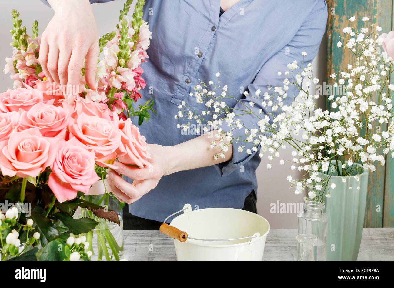 Work Sorting Roses Florist workplace: woman arranging a bouquet with roses and gypsophila ...