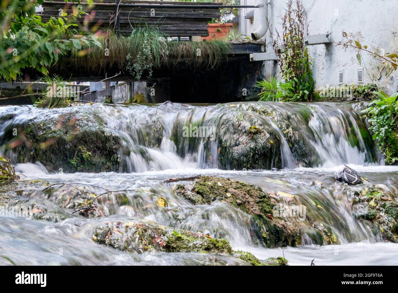 A small waterfall in the middle of the city Stock Photo
