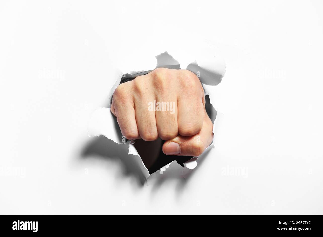 Fist punching through paper hires stock photography and images Alamy