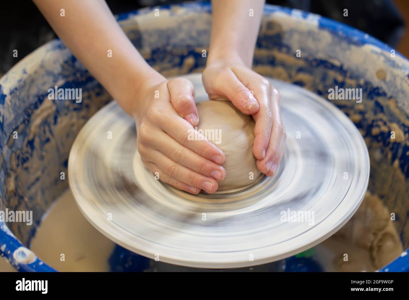 Potter's hands at work. Closeup of a potter's hands with a product on
