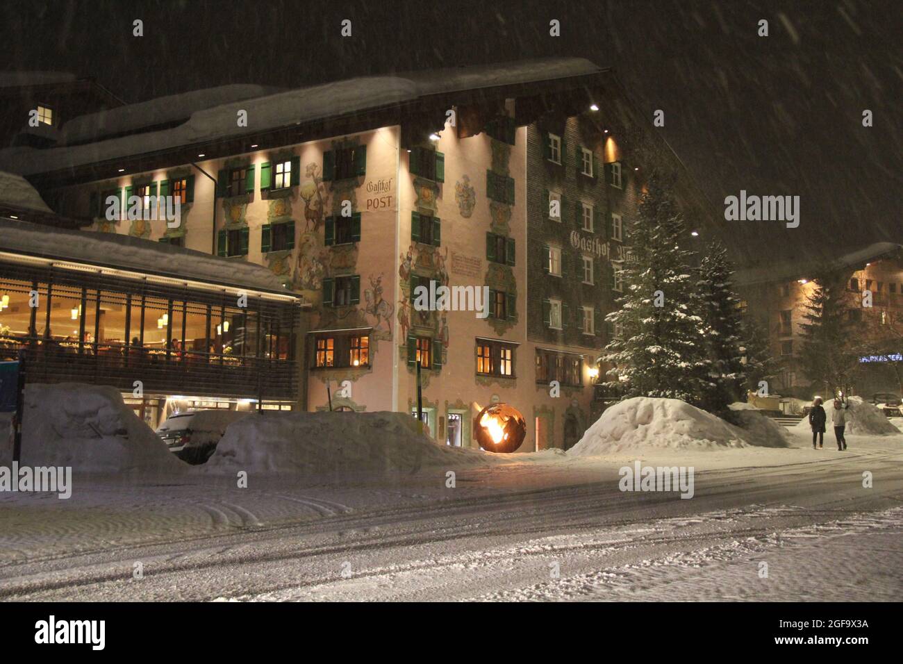 Lech, Austria - 04 01 2018: Nice Winter Night in street of Lech, an Austrian Ski Resort Village with Chalet and Snowing Stock Photo