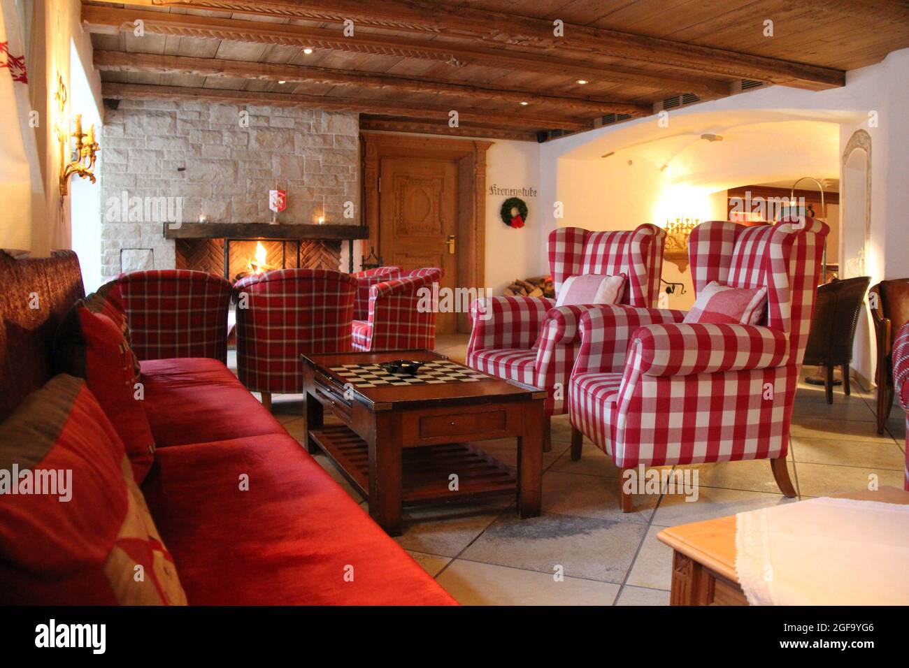Lech, Austria - 03 18 2018: Cosy Mountain House Interior with Armchairs and Fireplace Stock Photo