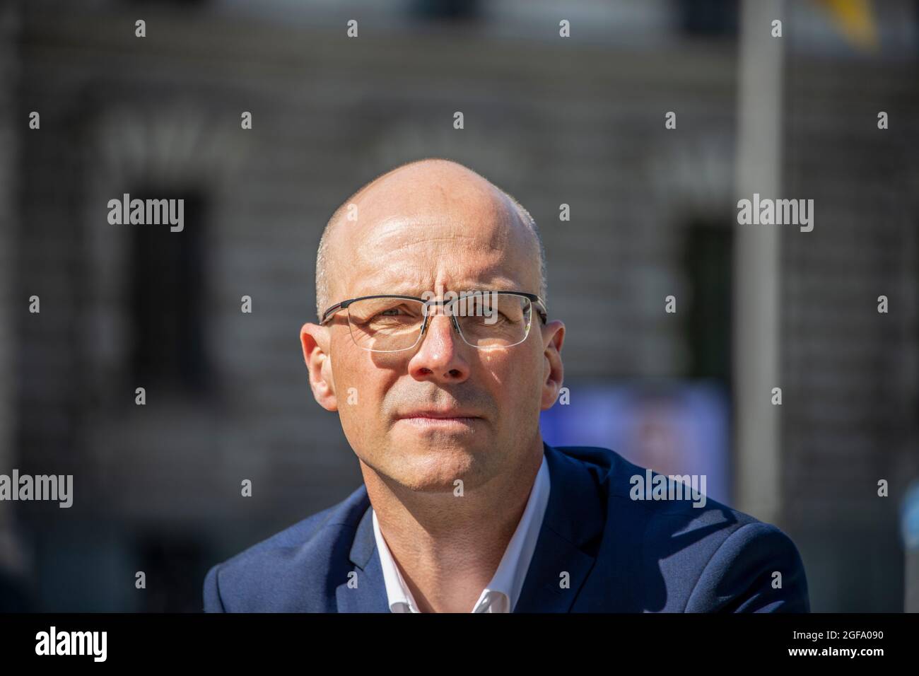 Profile of a young man wearing glasses, looking at the camera Stock Photo