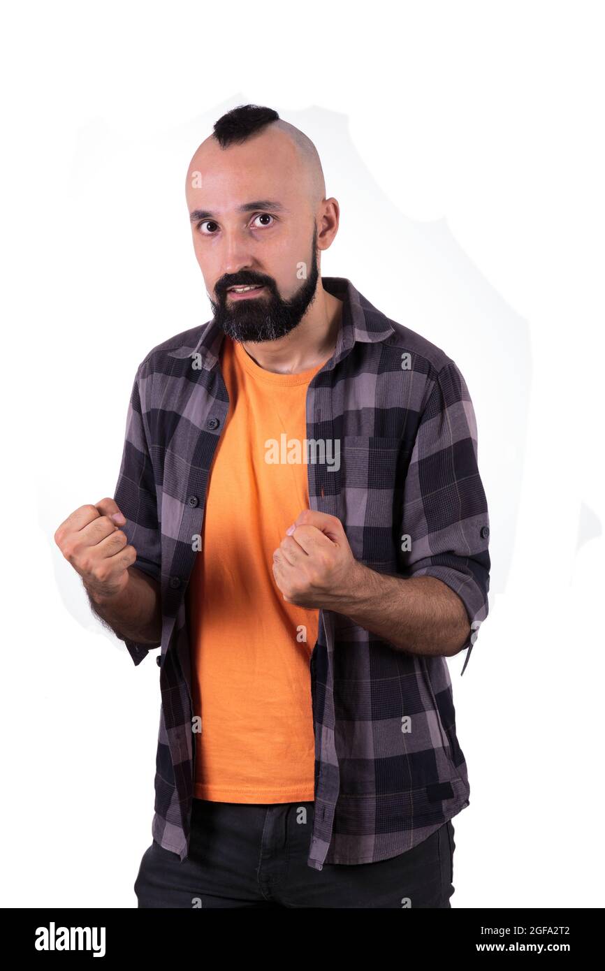 Energetic young man looking at camera and holding his fists Stock Photo