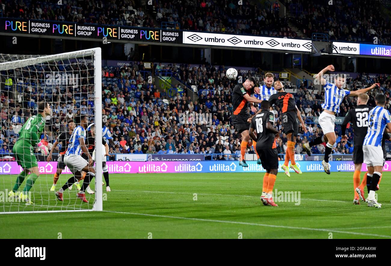 Huddersfield Town’s Tom Lees scores his sides first goal during the Carabao Cup second round match at John Smiths' Stadium, Huddersfield. Picture date: Tuesday August 24, 2021. Stock Photo