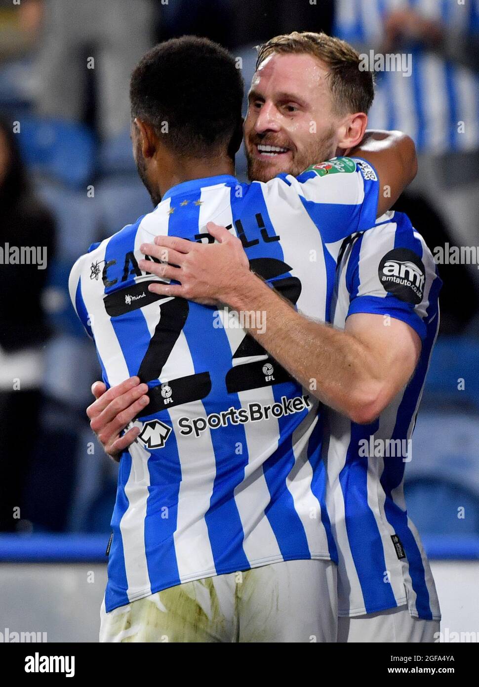 Huddersfield Town’s Tom Lees celebrates with team mate Fraizer Campbell after scoring his sides first goal during the Carabao Cup second round match at John Smiths' Stadium, Huddersfield. Picture date: Tuesday August 24, 2021. Stock Photo