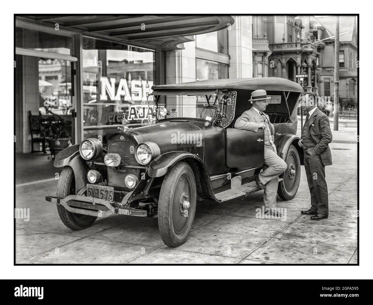 1925 Nash Tourer Automobile on New York Nash Car dealer forecourt with salesman and owner in discussion New York USA Stock Photo
