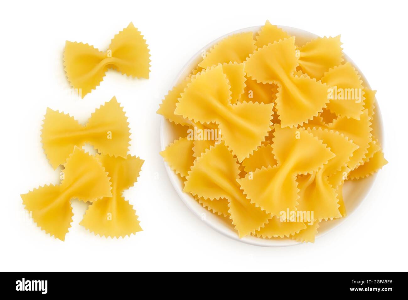 Bow tie pasta in the bowl isolated on white background with clipping path and full depth of field. Top view. Flat lay. Stock Photo