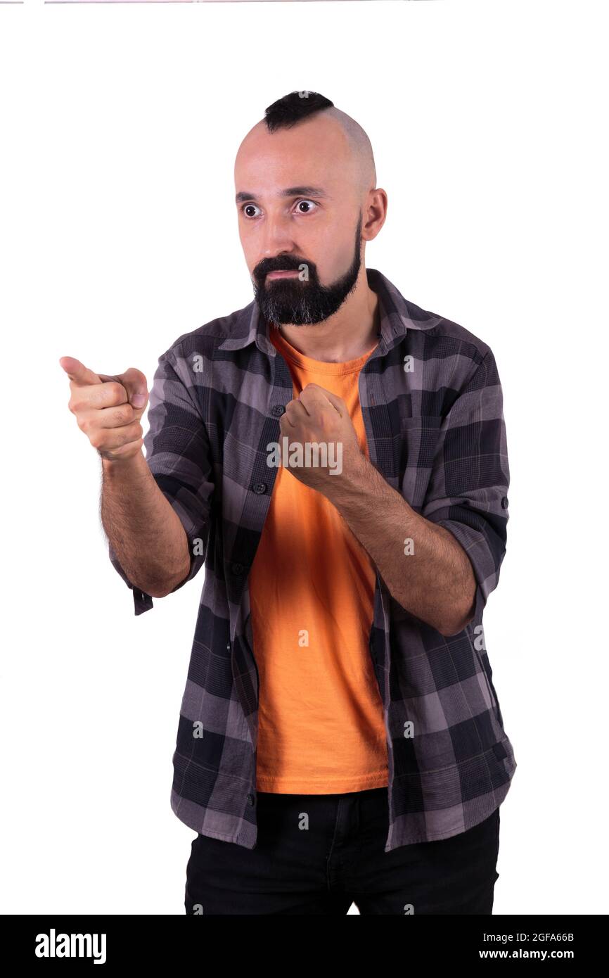 Aggresive young man holding his fist and threatening someone Stock Photo