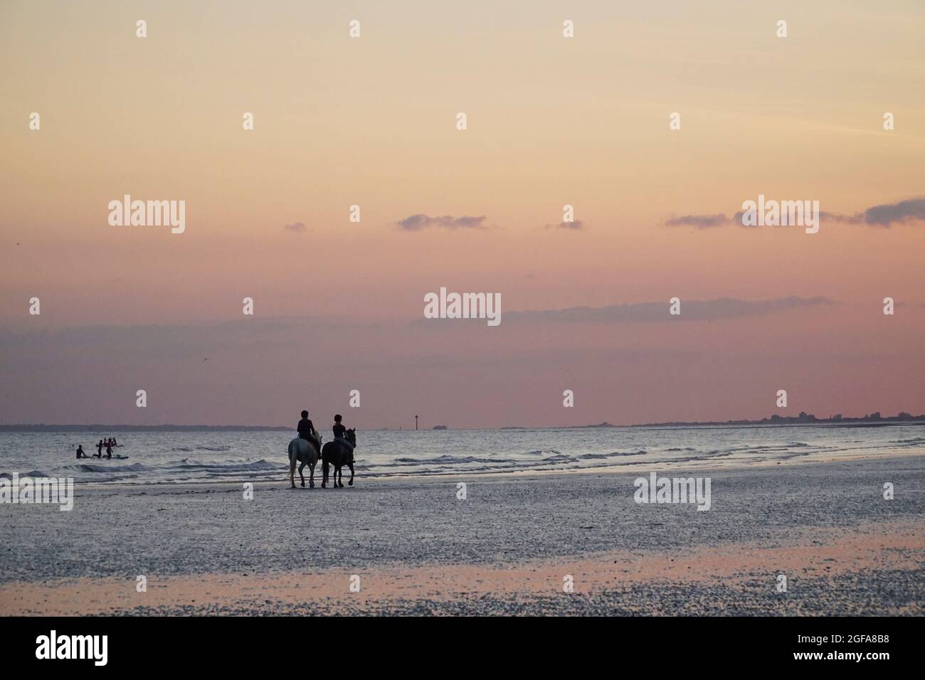 UK Weather, 24 August 2021 Just before sunset at East Wittering beach in West Sussex, two