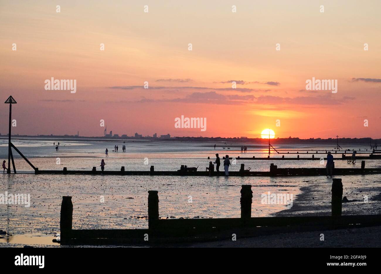 UK Weather, 24 August 2021 At East Wittering beach in West Sussex, people swim, play, run or