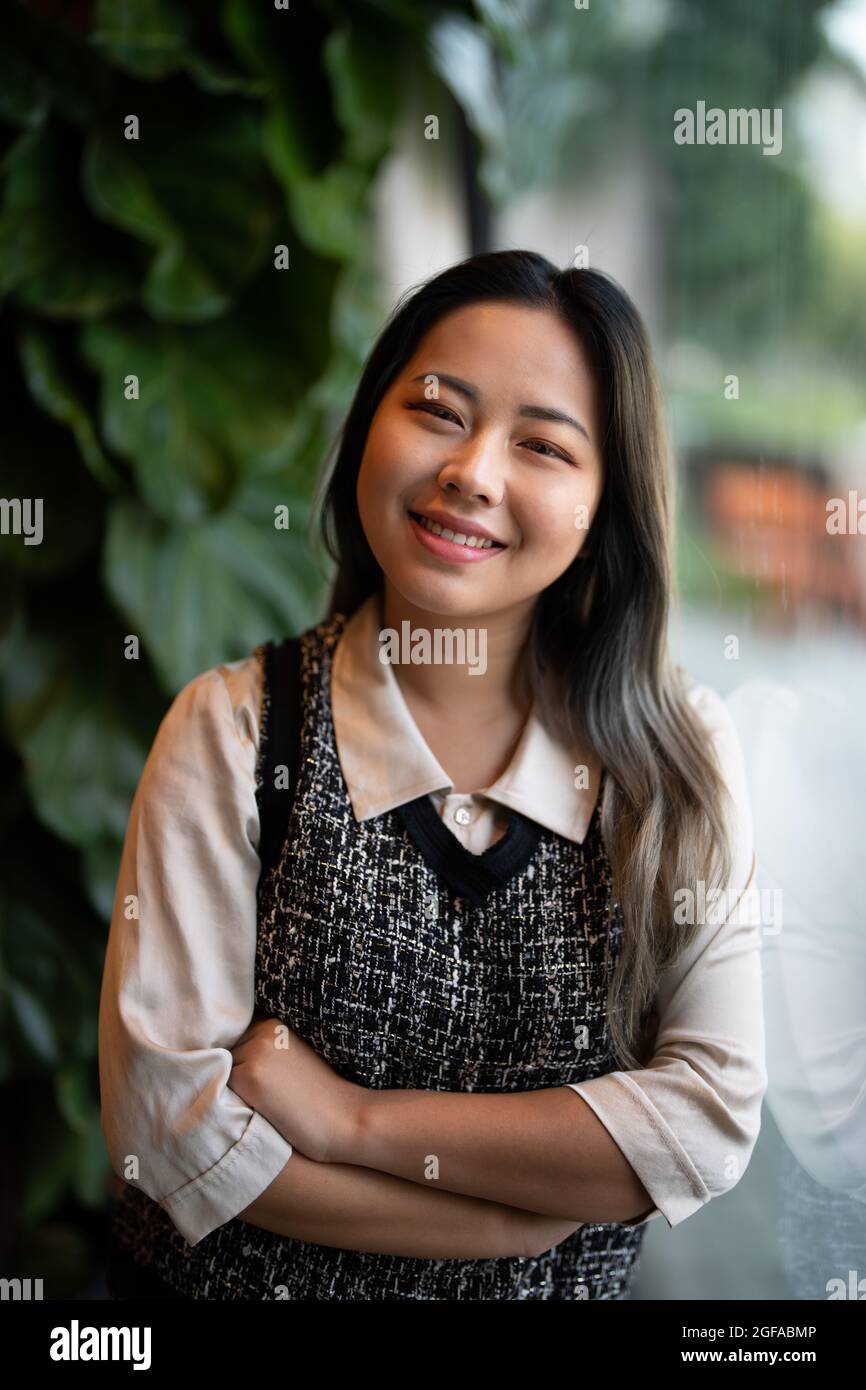 Young Asian Woman Office Worker / Data Scientist Looking Out Window Stock Photo