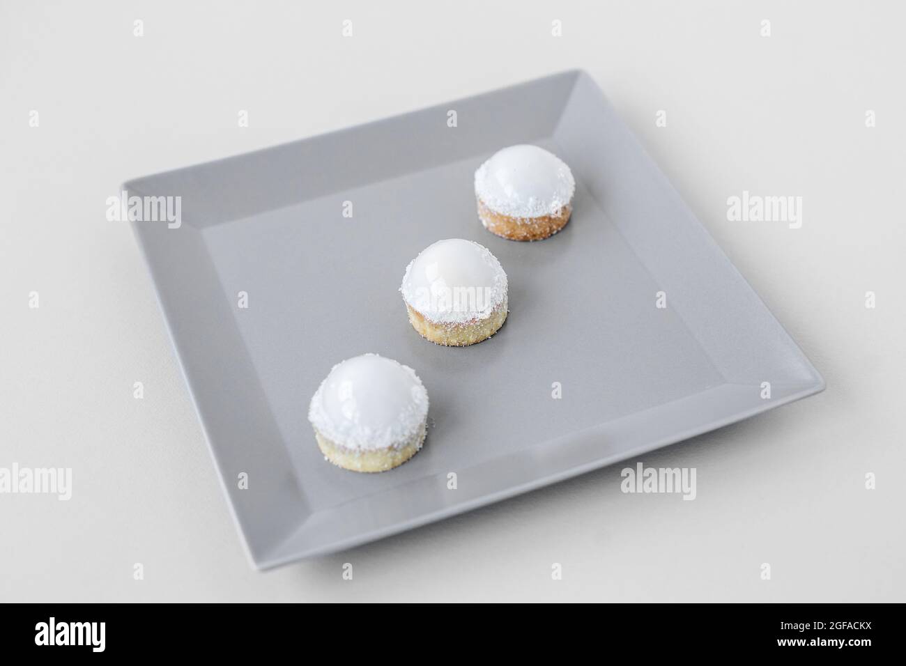 Tartlets on a stylish gray plate in a restaurant, on-site catering, a delicious and stylish dessert Stock Photo